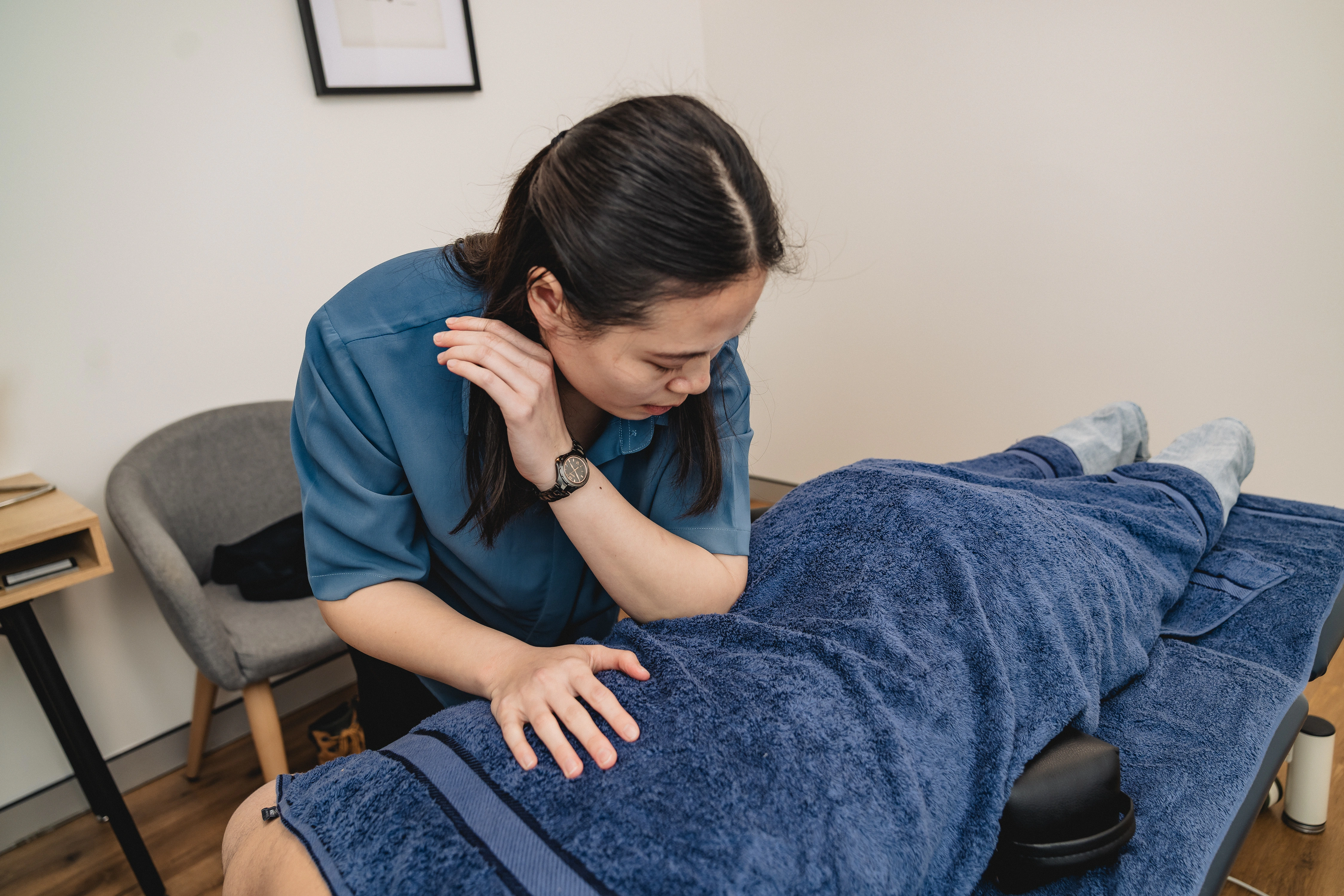 Chiropractor Gianna Lau providing hands-on treatment to a patient at the Chatswood clinic