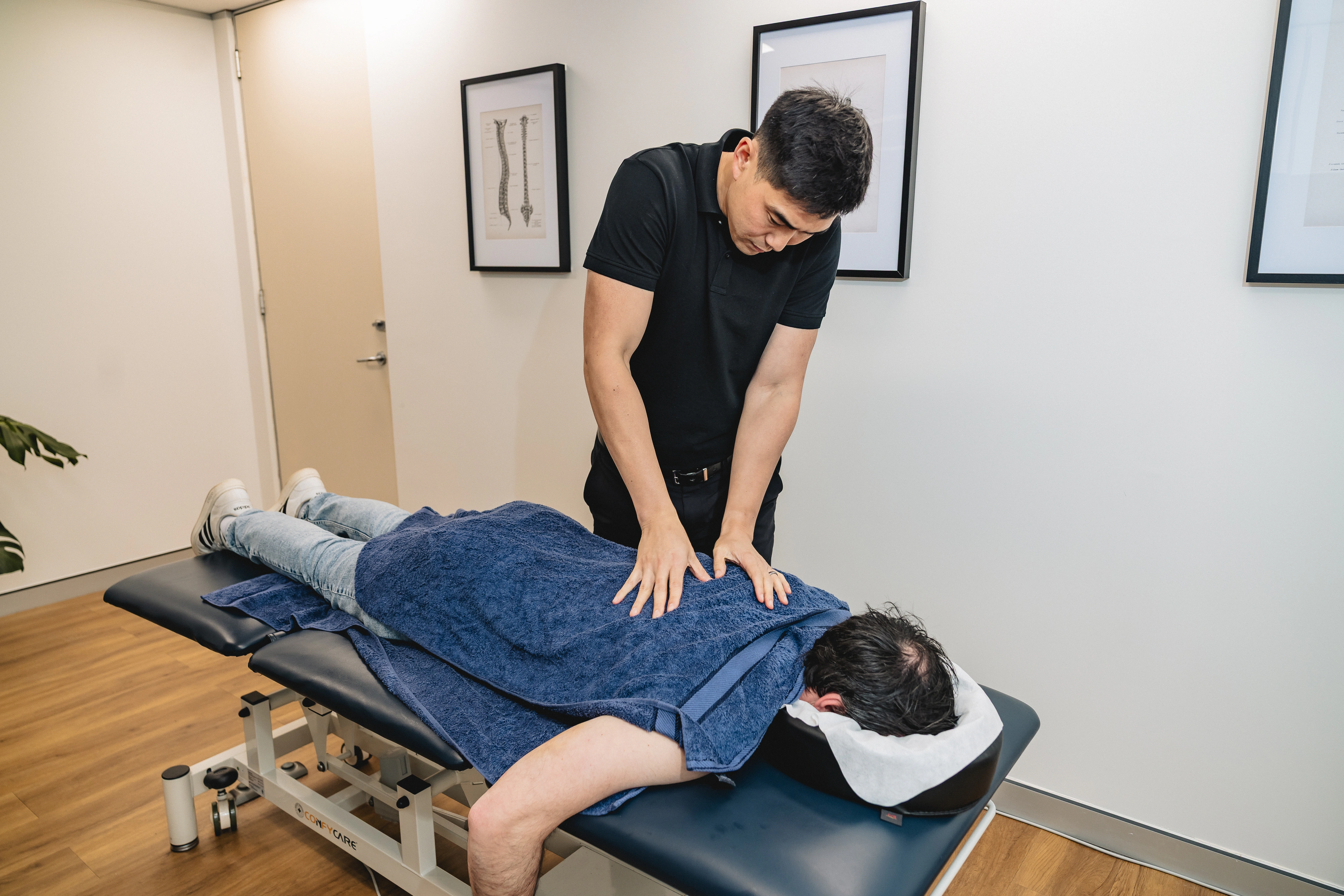 Chiropractor James Zheng providing hands-on treatment to a patient